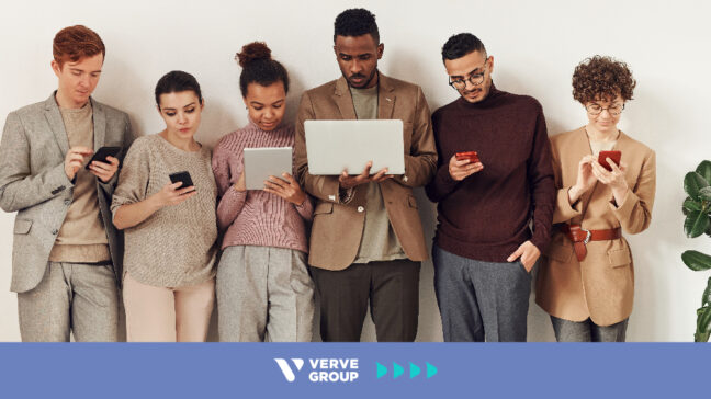 People standing next to each other looking at their devices